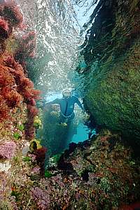freediver going through a narrow passage