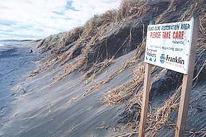 The sea carves a tall steep bank